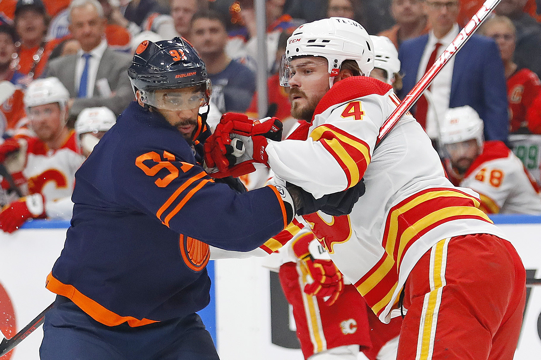 Edmonton Oilers forward Evander Kane (left) battle for position with Calgary Flames defensemen Rasmus Andersson (right) during Game 3 of the 2022 Stanley Cup Playoffs