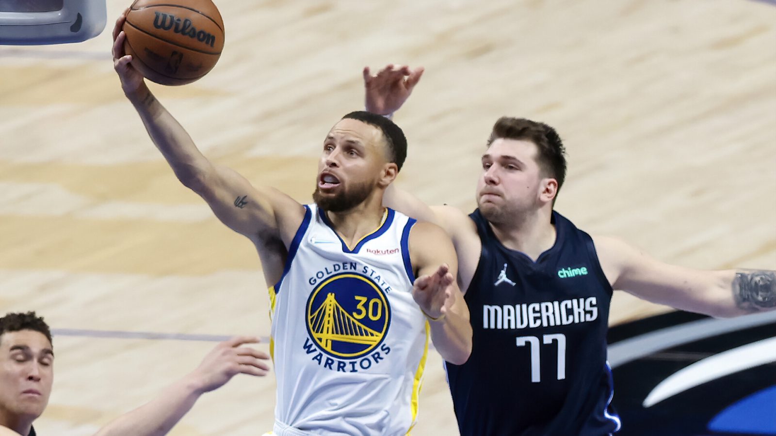 Golden State Warriors guard Stephen Curry (30) shoots past Dallas Mavericks guard Luka Doncic (77) during the second quarter in game three of the 2022 Western Conference finals at American Airlines Center.
