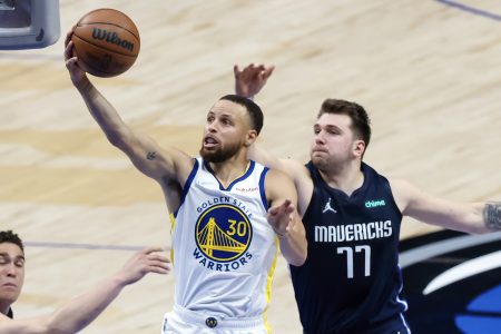 Golden State Warriors guard Stephen Curry (30) shoots past Dallas Mavericks guard Luka Doncic (77) during the second quarter in game three of the 2022 Western Conference finals at American Airlines Center.
