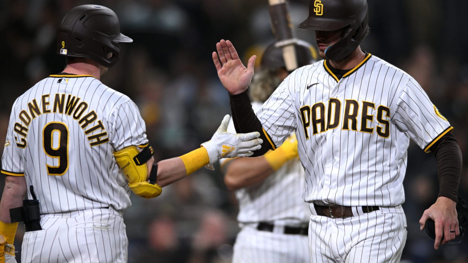 San Diego Padres right fielder Wil Myers (right) is congratulated by shortstop Jake Cronenworth (9) after scoring a run on a bunt against the Milwaukee Brewers