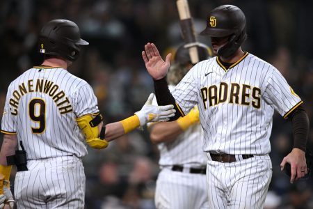 San Diego Padres right fielder Wil Myers (right) is congratulated by shortstop Jake Cronenworth (9) after scoring a run on a bunt against the Milwaukee Brewers