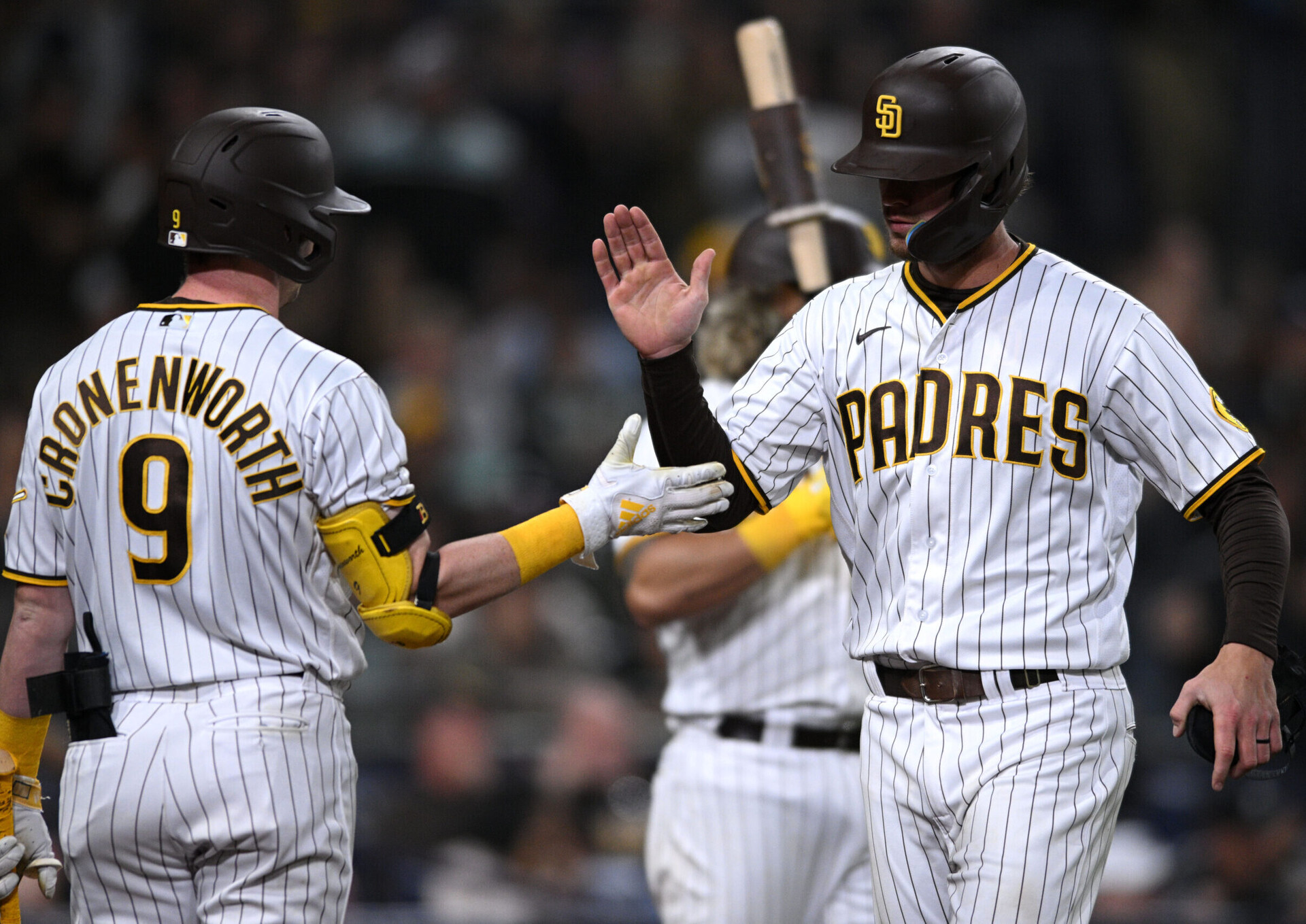 San Diego Padres right fielder Wil Myers (right) is congratulated by shortstop Jake Cronenworth (9) after scoring a run on a bunt against the Milwaukee Brewers