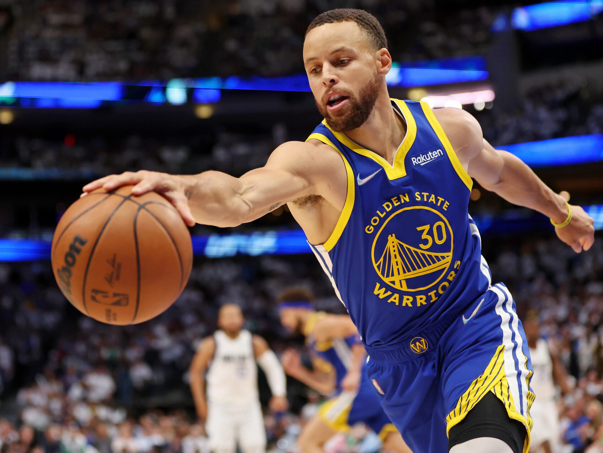 Golden State Warriors guard Stephen Curry stretches to reach for the ball with his right hand against the Dallas Mavericks on Tuesday, May 24, 2022, in Dallas.