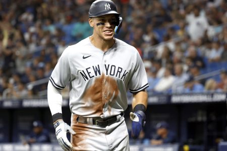 New York Yankees right fielder Aaron Judge smiles as he jogs to his dugout after scoring during the sixth inning against the Tampa Bay Rays