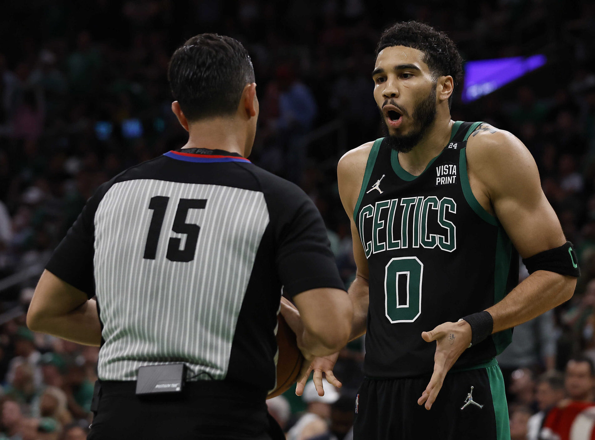 Boston Celtics forward Jayson Tatum, right, argues with referee Zach Zarba, left, with back to camera, on Friday, May 27, 2022, in Boston.