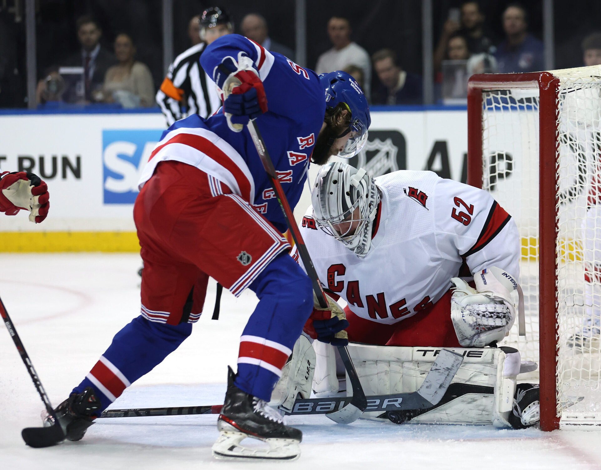 Carolina Hurricanes goaltender Pyotr Kochetkov (right) makes a save against New York Rangers defenseman Ryan Lindgren (left) during Game 6 of the second round of the 2022 Stanley Cup Playoffs