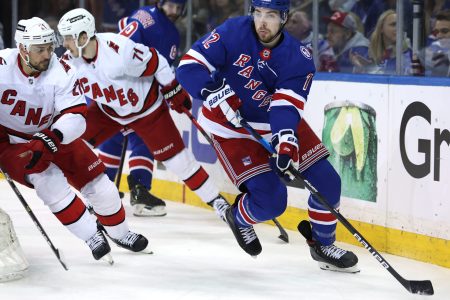 New York Rangers center Filip Chytil (right) controls the puck against Carolina Hurricanes right wing Nino Niederreiter (left) and right wing Jesper Fast (center) during Game 6 of the second round of the 2022 Stanley Cup Playoffs