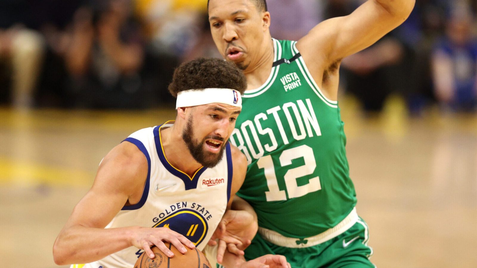 Golden State Warriors guard Klay Thompson (left) dribbles the baseball with his right hand and tries to get around Boston Celtics defender Grant Williams during Game 1 of the 2022 NBA Finals