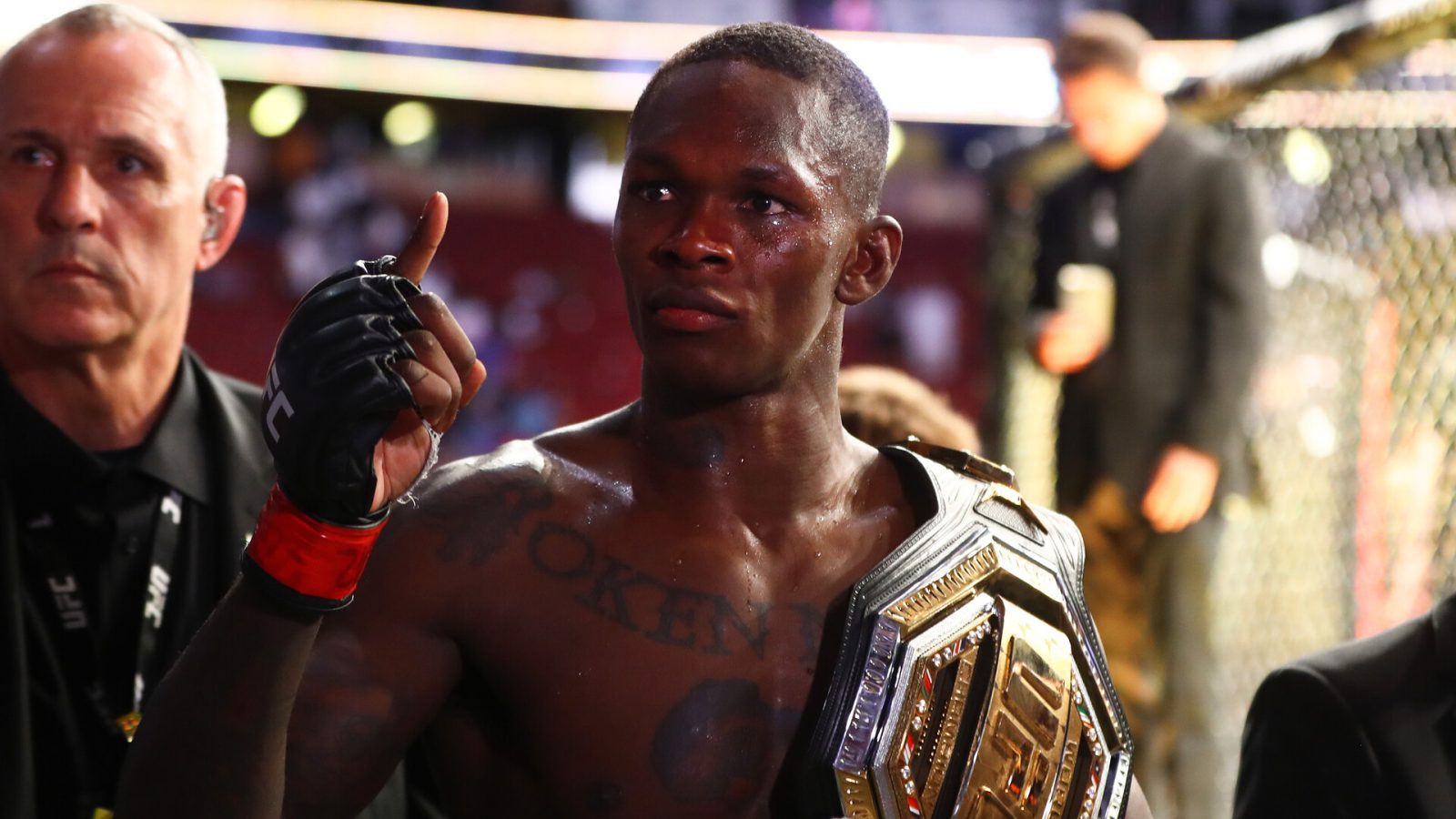 Israel Adesanya celebrates with the championship belt during UFC 263