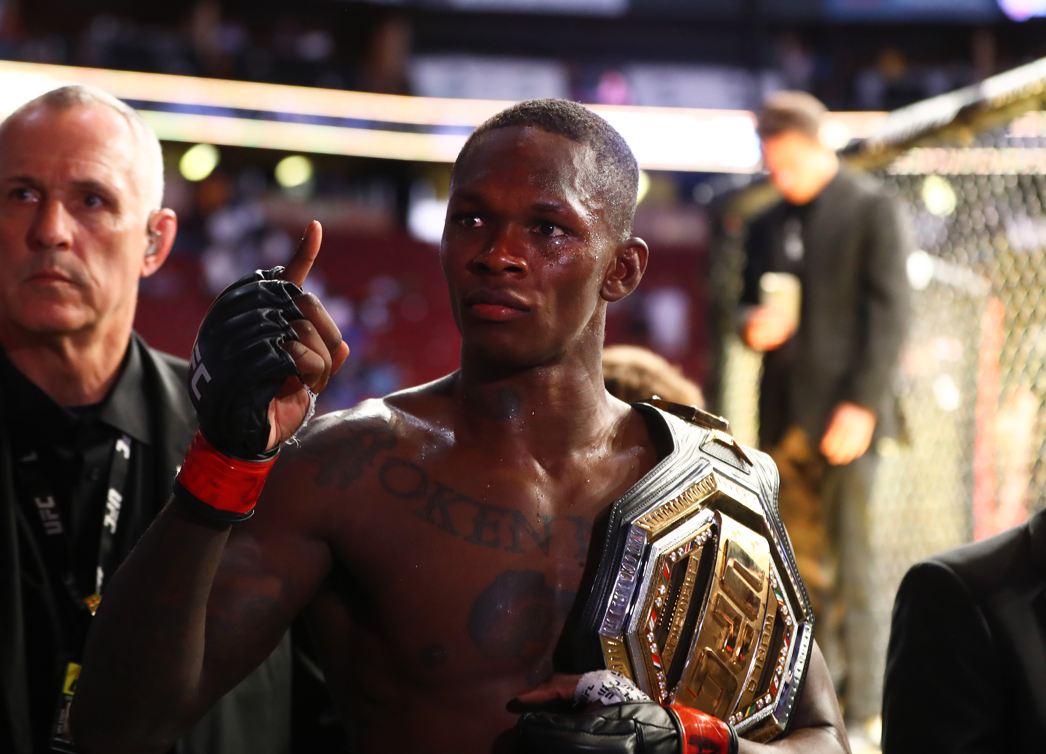 Israel Adesanya celebrates with the championship belt during UFC 263