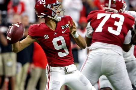 Alabama Crimson Tide quarterback Bryce Young, left, throws a pass during the second half against the Georgia Bulldogs in the 2022 CFP college football national championship game at Lucas Oil Stadium on Jan. 10, 2022.
