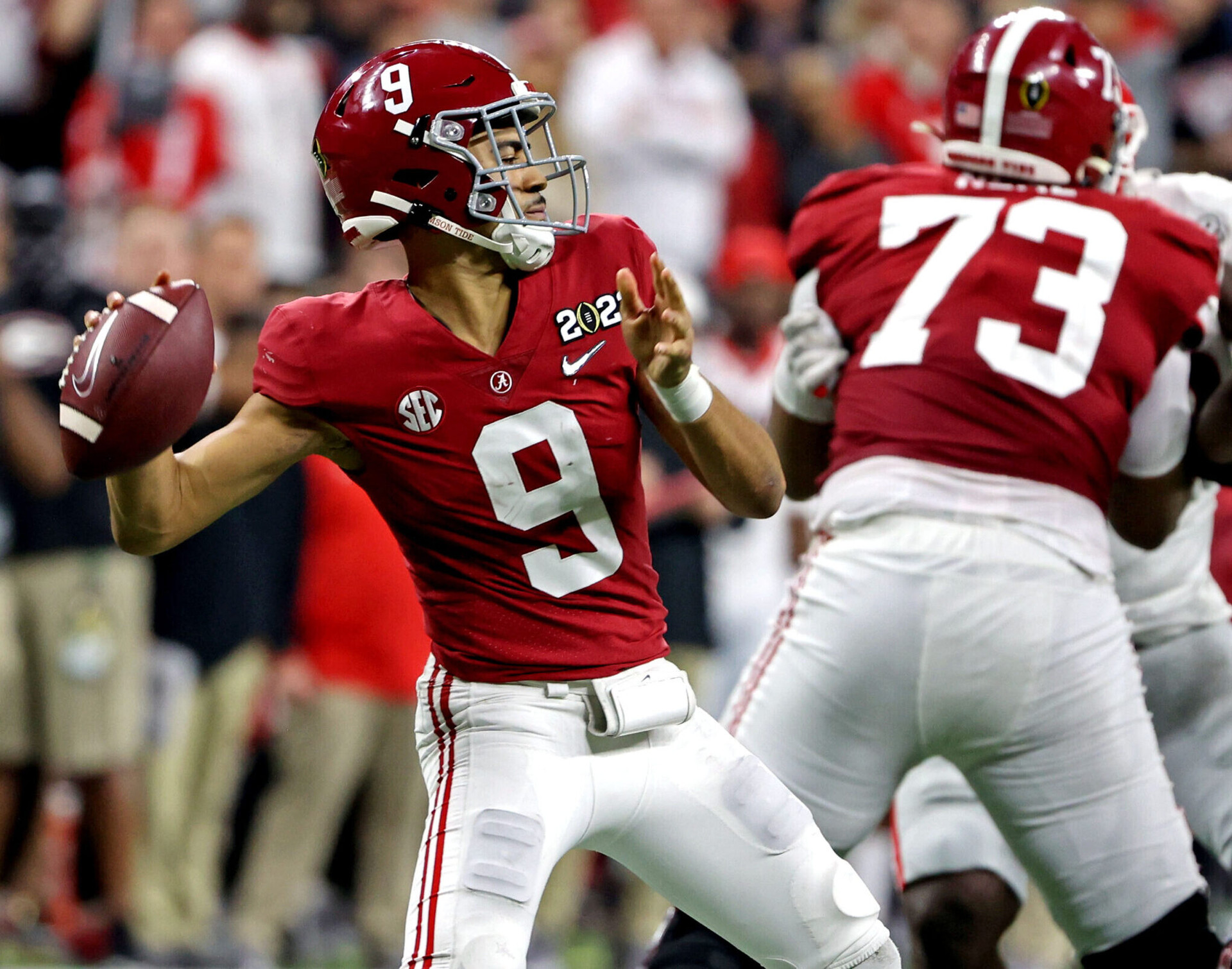 Alabama Crimson Tide quarterback Bryce Young, left, throws a pass during the second half against the Georgia Bulldogs in the 2022 CFP college football national championship game at Lucas Oil Stadium on Jan. 10, 2022.
