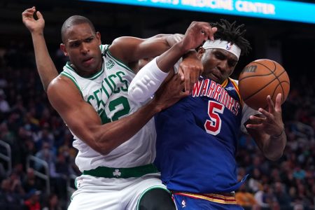 Boston Celtics center Al Horford, left, and Golden State Warriors center Kevon Looney, right, battle for a rebound March 16, 2022, in San Francisco.