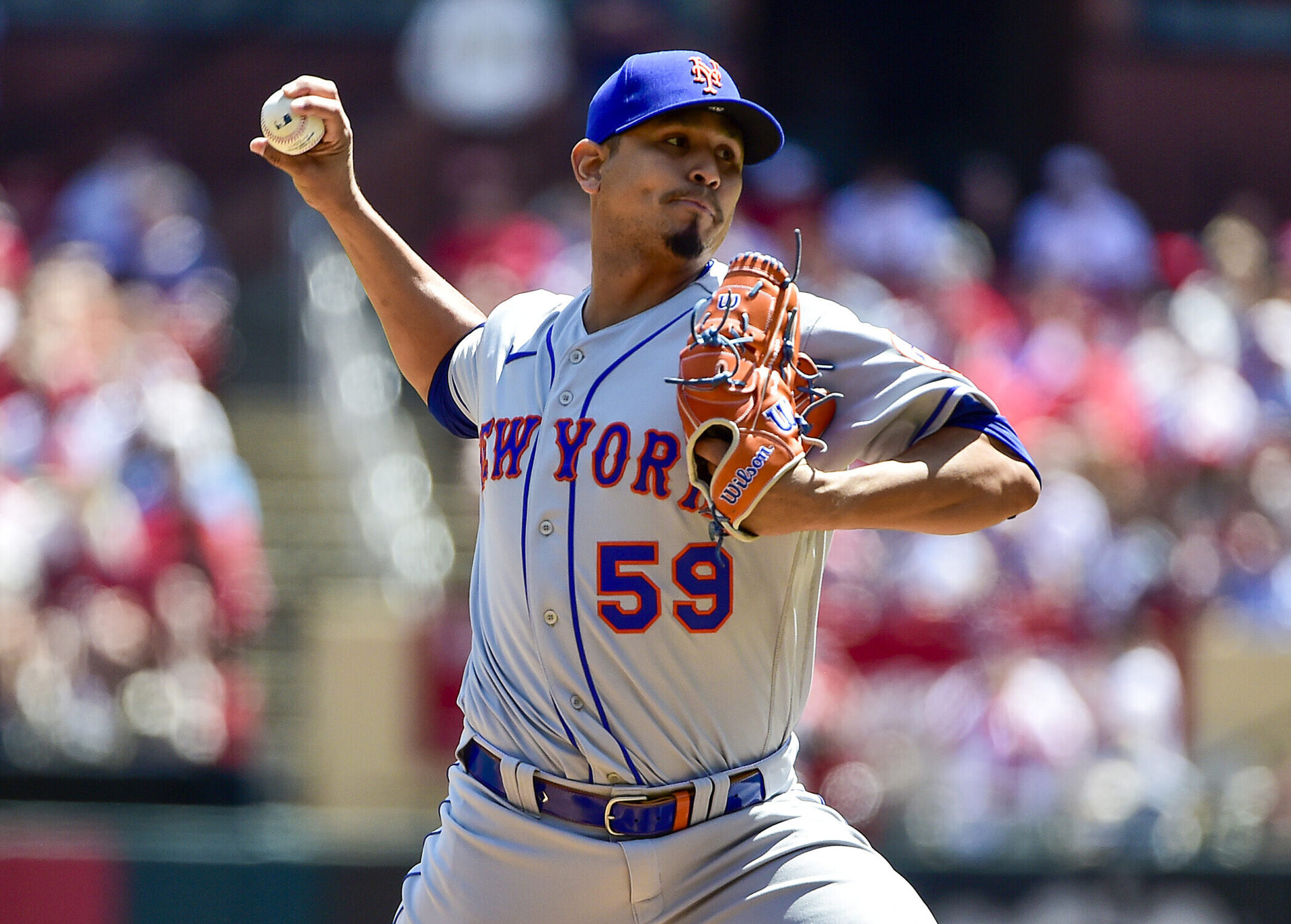 New York Mets starting pitcher Carlos Carrasco grips the ball in his right hand and delivers a pitch against the St. Louis Cardinals