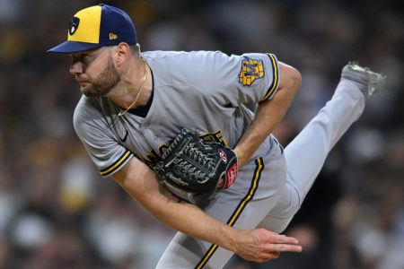Milwaukee Brewers right-handed pitcher Adrian Houser follows through on a delivery with his right leg in the air May 23, 2022, in San Diego.