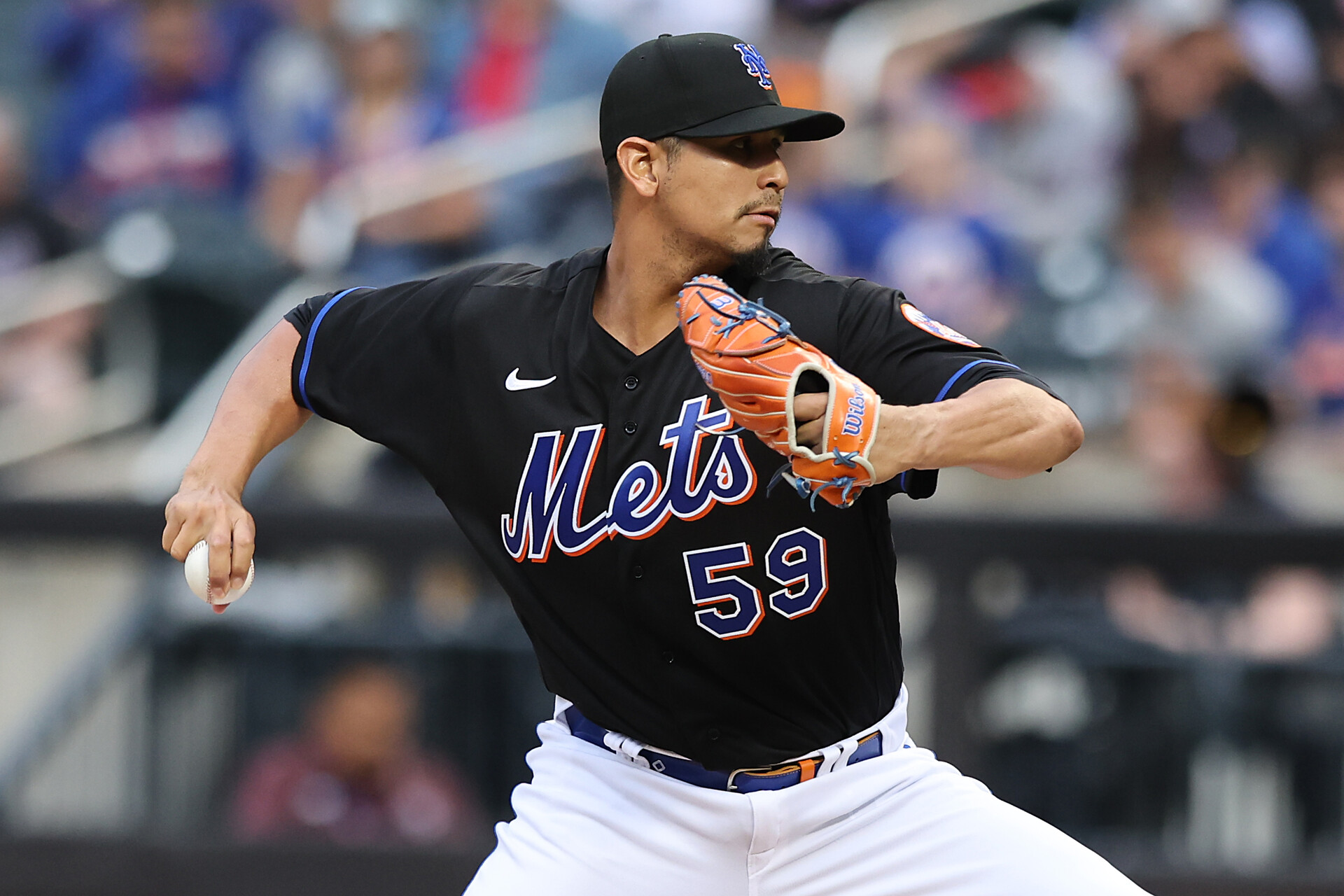 New York Mets right-handed starting pitcher Carlos Carrasco grips the ball with his right and and prepares to deliver a pitch against the Philadelphia Phillies