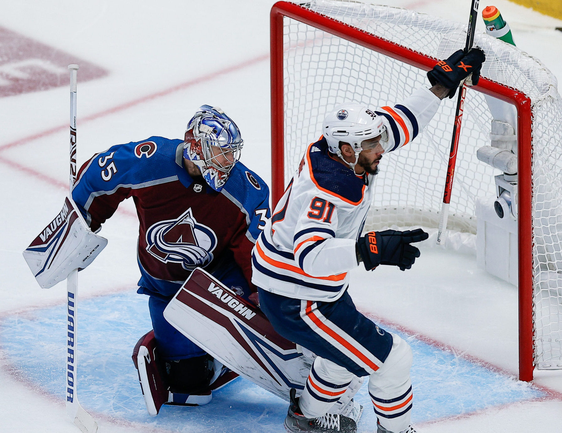 Edmonton Oilers left wing Evander Kane (right) raises his arms in celebration after scoring a goal against Colorado Avalanche goaltender Darcy Kuemper (left) in the first period in Game 1 of the 2022 NHL Western Conference Finals
