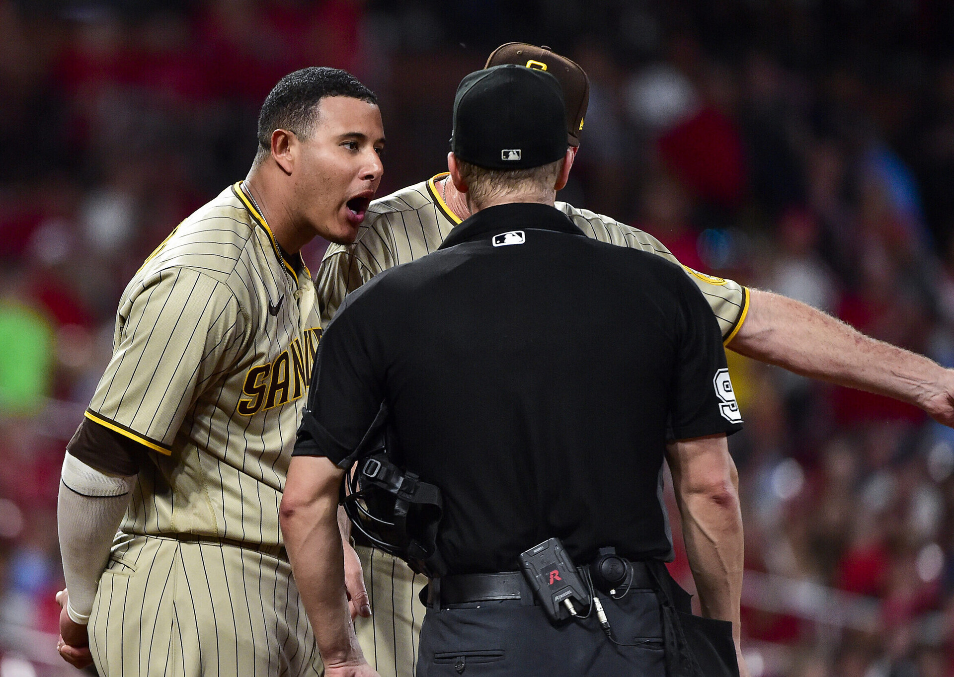San Diego Padres third baseman Manny Machado, left, argues with umpire Chris Segal, right, with back to camera, after being ejected May 31, 2022, in St. Louis.