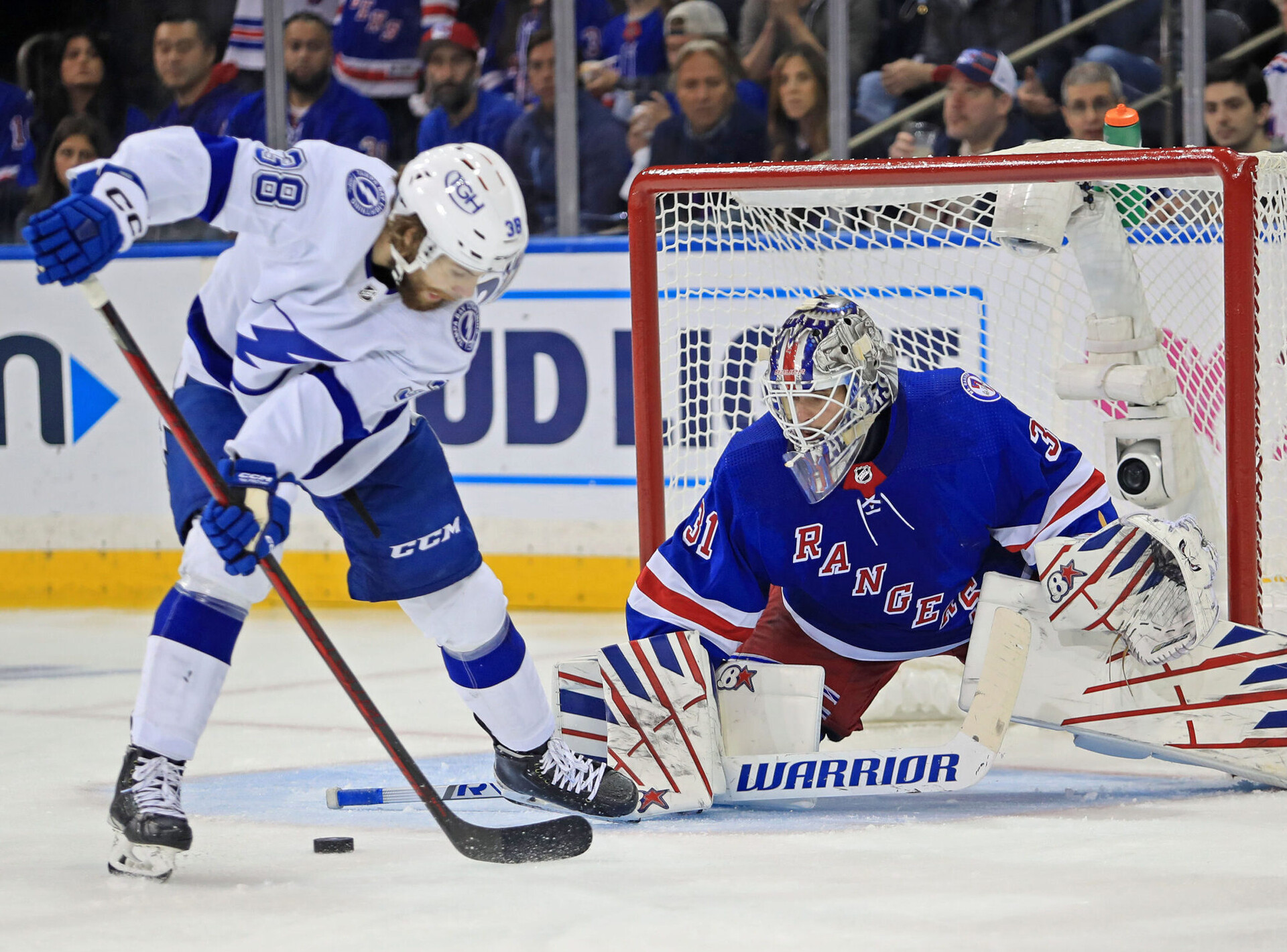 New York Rangers goalie Igor Shesterkin (right) makes a save on a shot attempt by Tampa Bay Lightning left wing Brandon Hagel (left) in the second period of Game 1 of the Eastern Conference Final of the 2022 Stanley Cup Playoffs