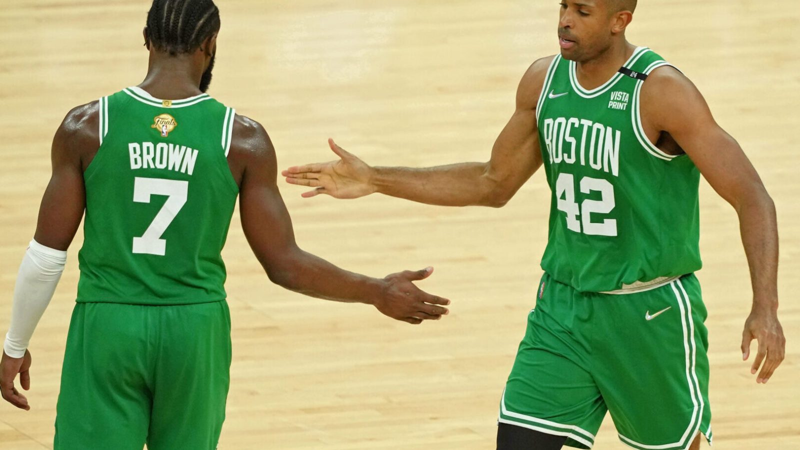 Boston Celtics center Al Horford, right, high fives guard Jaylen Brown, left, after a play against the Golden State Warriors during the second half of game one of the 2022 NBA Finals at Chase Center on June 2, 2022.