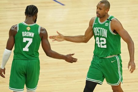 Boston Celtics center Al Horford, right, high fives guard Jaylen Brown, left, after a play against the Golden State Warriors during the second half of game one of the 2022 NBA Finals at Chase Center on June 2, 2022.