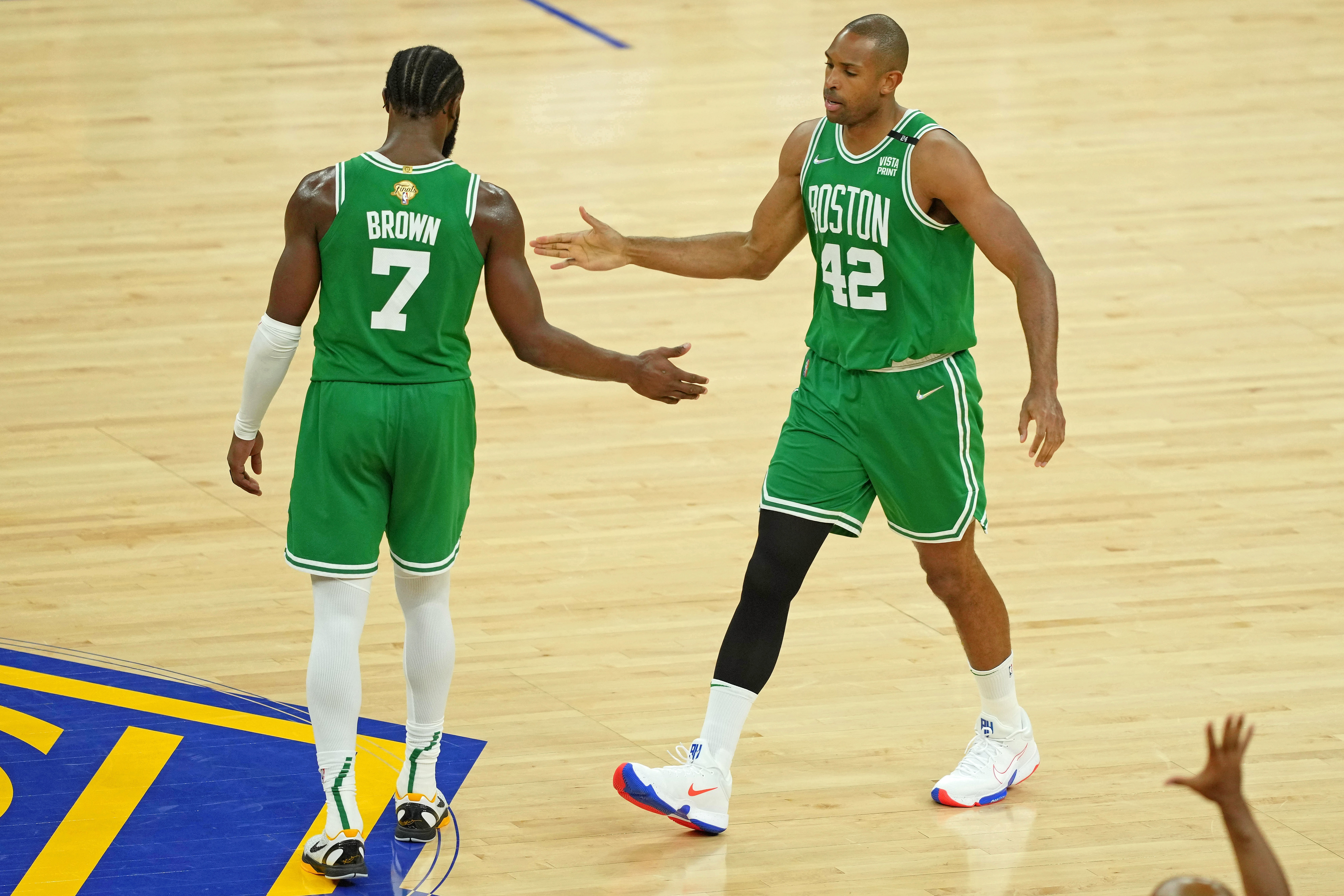 Boston Celtics center Al Horford, right, high fives guard Jaylen Brown, left, after a play against the Golden State Warriors during the second half of game one of the 2022 NBA Finals at Chase Center on June 2, 2022.