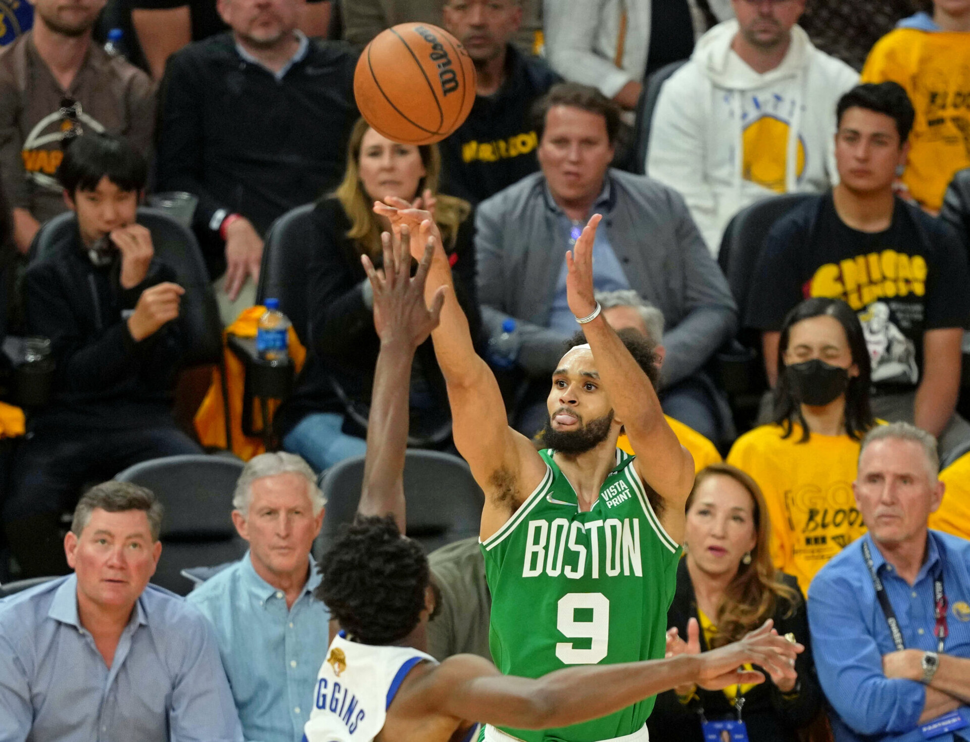Boston Celtics guard Derrick White, center, shoots over Golden State Warriors forward Andrew Wiggins, center, with back to camera, on June 2, 2022, in San Francisco.