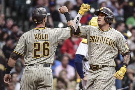 San Diego Padres third baseman Manny Machado (right) gives teammate and catcher Austin Nola (left) a forearm bash after hitting a 3-run home run against the Milwaukee Brewers