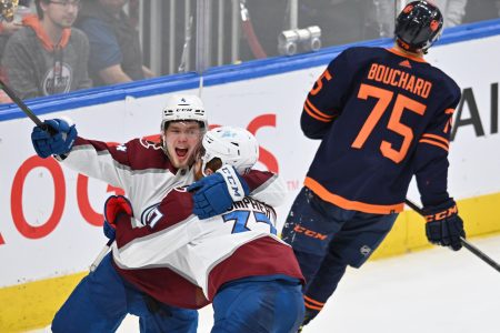 Colorado Avalanche left wing J.T. Compher (right) celebrates a goal with teammate Bowen Byram (left) as Edmonton defenseman Evan Bouchard skates away during Game 4 of the Western Conference Finals of the 2022 Stanley Cup Playoffs