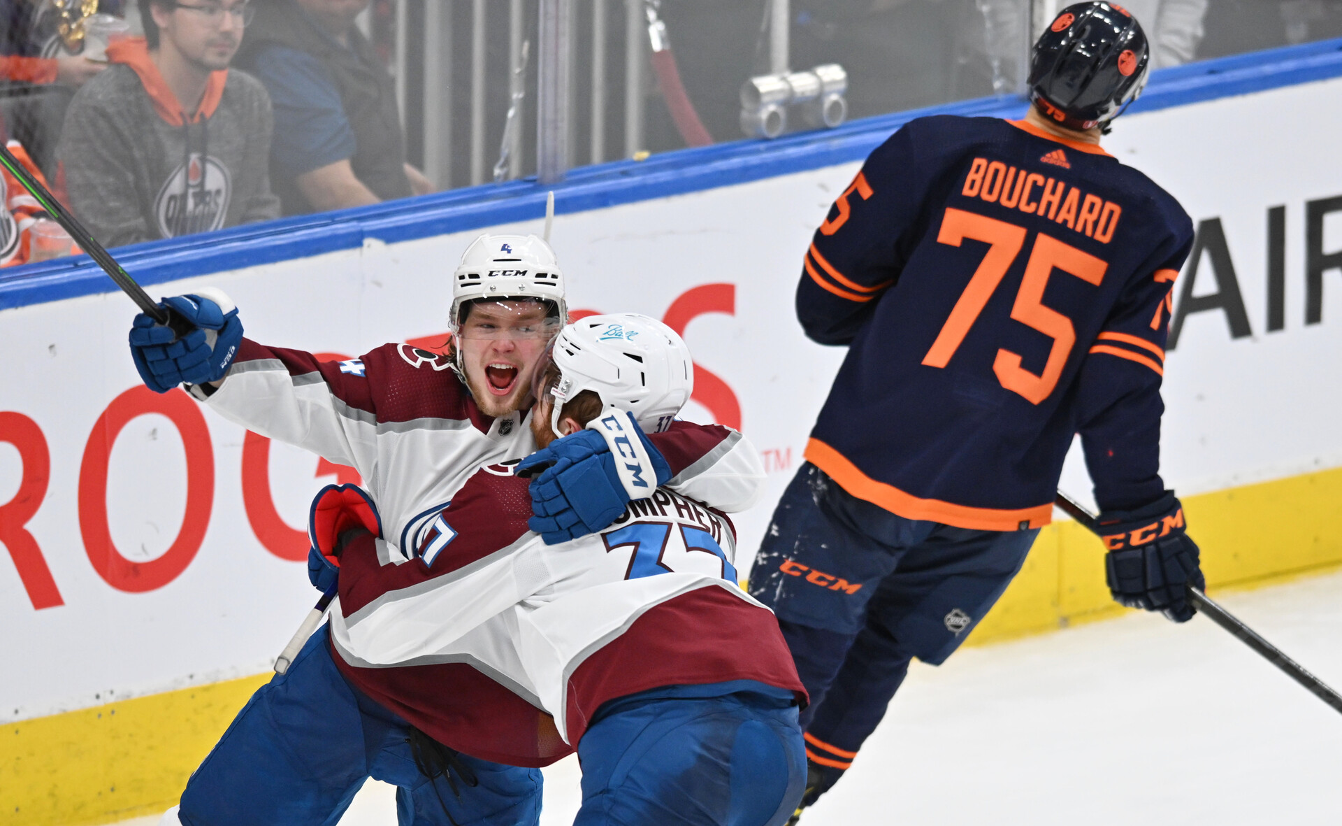 Colorado Avalanche left wing J.T. Compher (right) celebrates a goal with teammate Bowen Byram (left) as Edmonton defenseman Evan Bouchard skates away during Game 4 of the Western Conference Finals of the 2022 Stanley Cup Playoffs