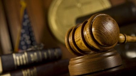 A gavel rests on a judge's bench.