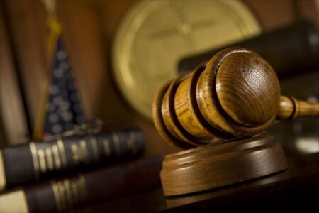 A gavel rests on a judge's bench.