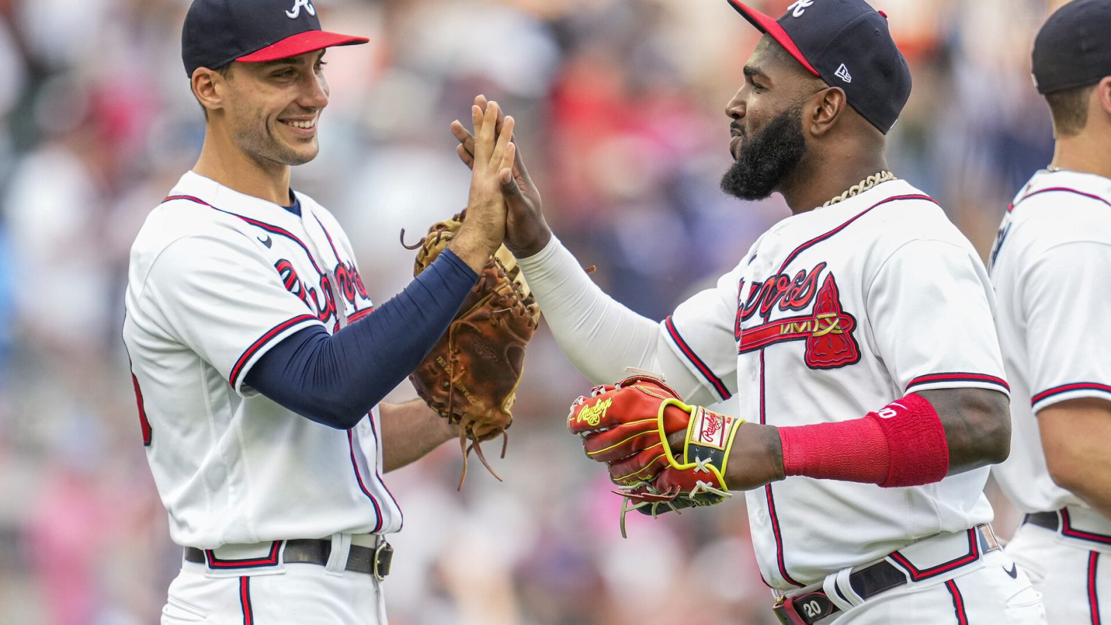 Atlanta Braves first baseman Matt Olson (28) and left fielder Marcell Ozuna (20) react after the Braves defeated the San Diego Padres at Truist Park.
