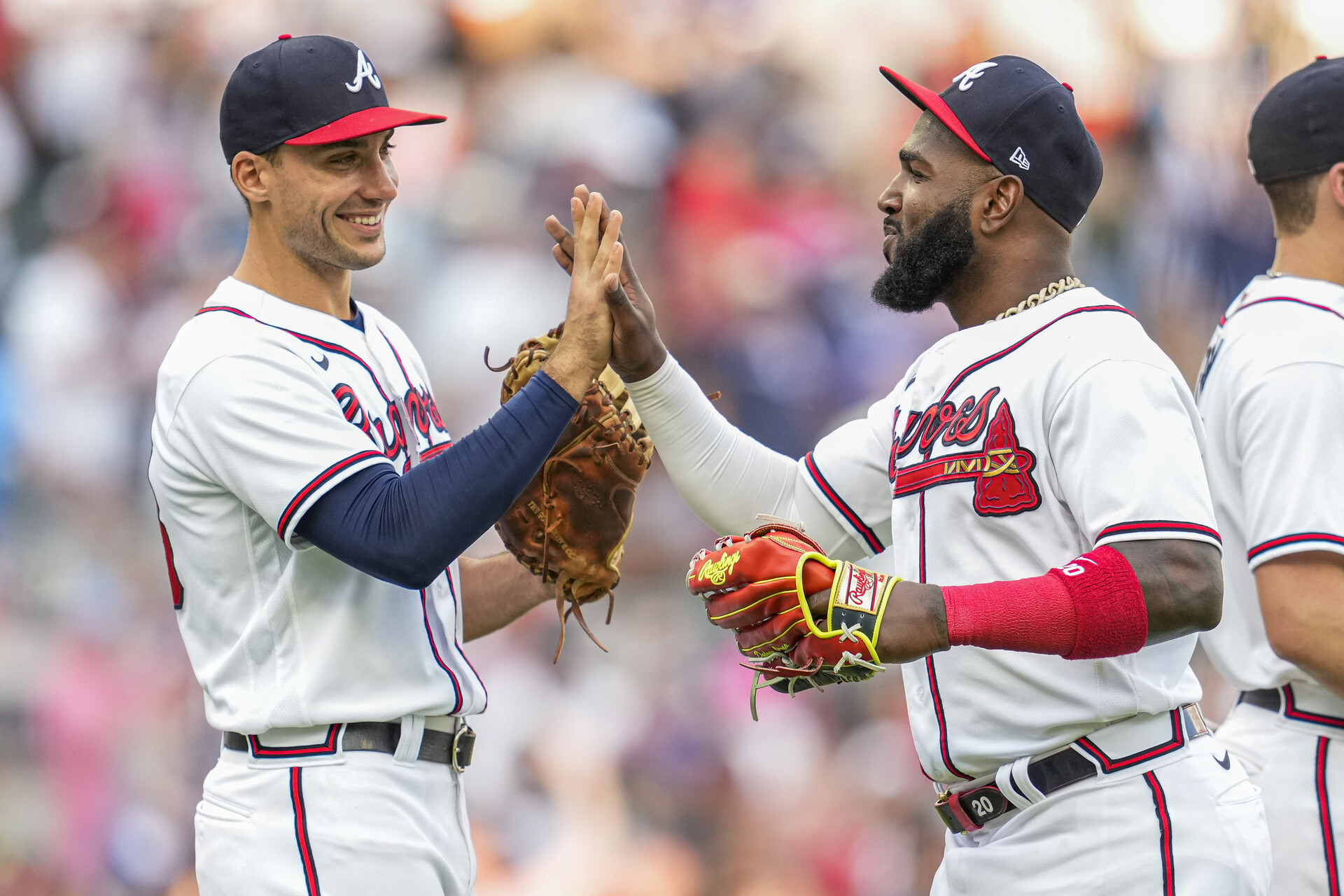 Atlanta Braves first baseman Matt Olson (28) and left fielder Marcell Ozuna (20) react after the Braves defeated the San Diego Padres at Truist Park.