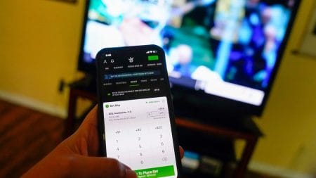 Photo illustration of the Draft Kings app on an iPhone.