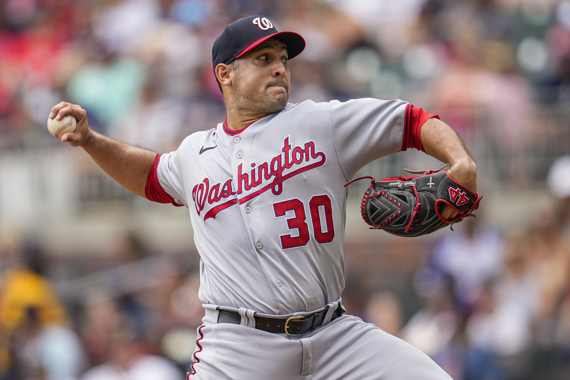 Nationals starting pitcher Paolo Espino (30) pitches against the Atlanta Braves during the first inning at Truist Park.