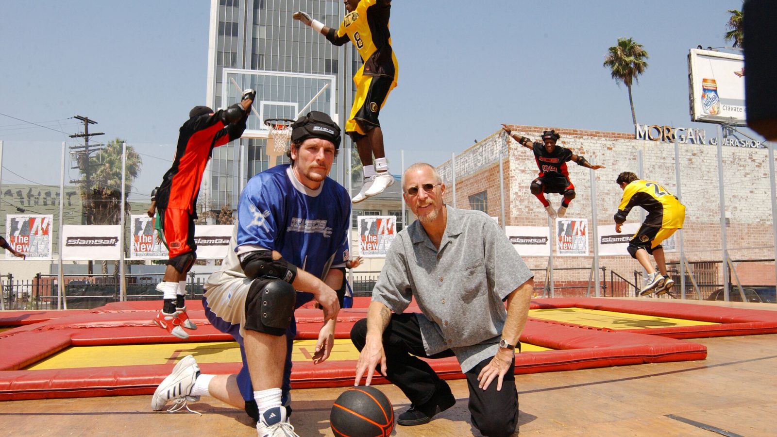 "Slamball" creator/player Mason Gordon (L) and part owner Pat Croce pose for a photograph while athletes demonstrate a drill for the new team action sport "Slamball" at a live exhibition at Nick on Sunset on July 30, 2002 in Los Angeles, California.