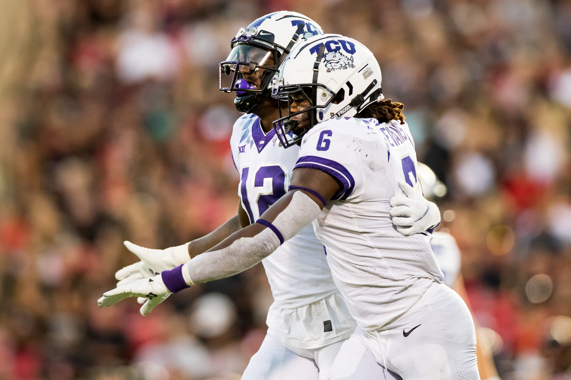 LUBBOCK, TEXAS - OCTOBER 09: Tight end Geor'Quarius Spivey #12 and running back Zach Evans #6 of the TCU Horned Frogs celebrate together during the first half of the college football game against the Texas Tech Red Raiders at Jones AT&T Stadium on October 09, 2021 in Lubbock, Texas.