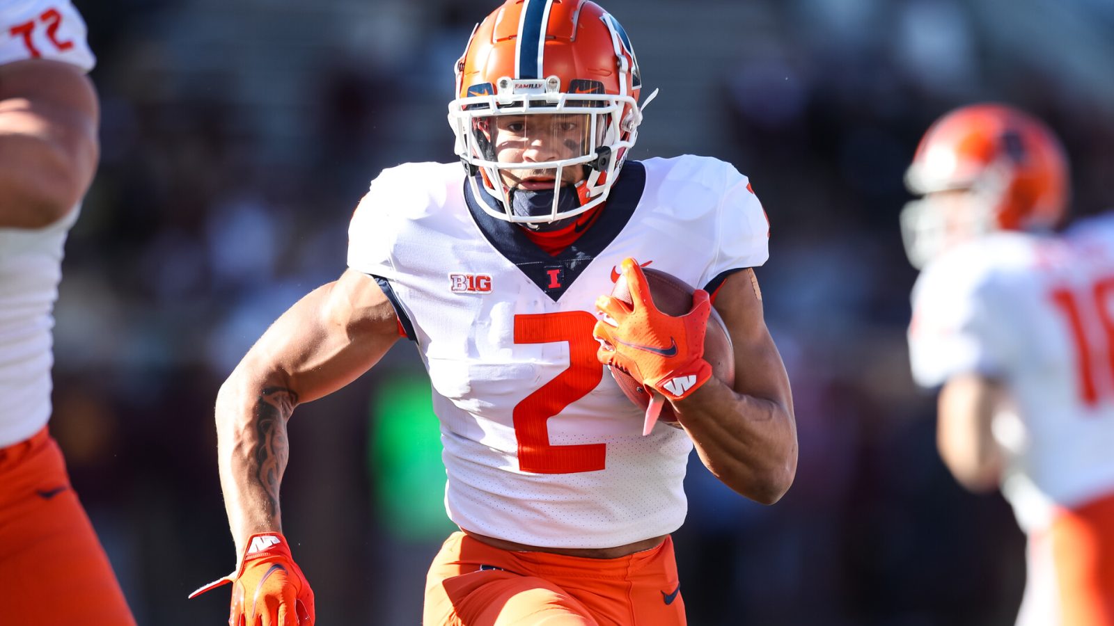 Chase Brown #2 of the Illinois Fighting Illini runs with the ball against the Minnesota Golden Gophers in the first quarter of the game at Huntington Bank Stadium on November 6, 2021 in Minneapolis, Minnesota. The Fighting Illini defeated the Golden Gophers 14-6.
