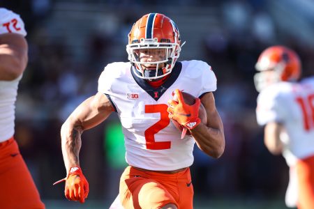 Chase Brown #2 of the Illinois Fighting Illini runs with the ball against the Minnesota Golden Gophers in the first quarter of the game at Huntington Bank Stadium on November 6, 2021 in Minneapolis, Minnesota. The Fighting Illini defeated the Golden Gophers 14-6.