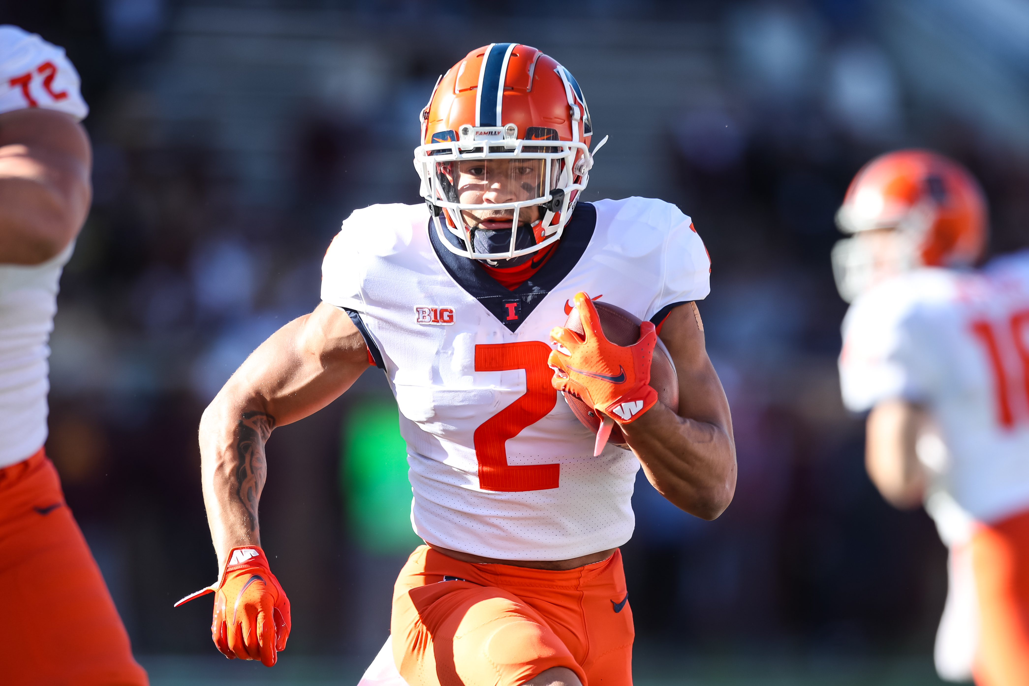 Chase Brown #2 of the Illinois Fighting Illini runs with the ball against the Minnesota Golden Gophers in the first quarter of the game at Huntington Bank Stadium on November 6, 2021 in Minneapolis, Minnesota. The Fighting Illini defeated the Golden Gophers 14-6.
