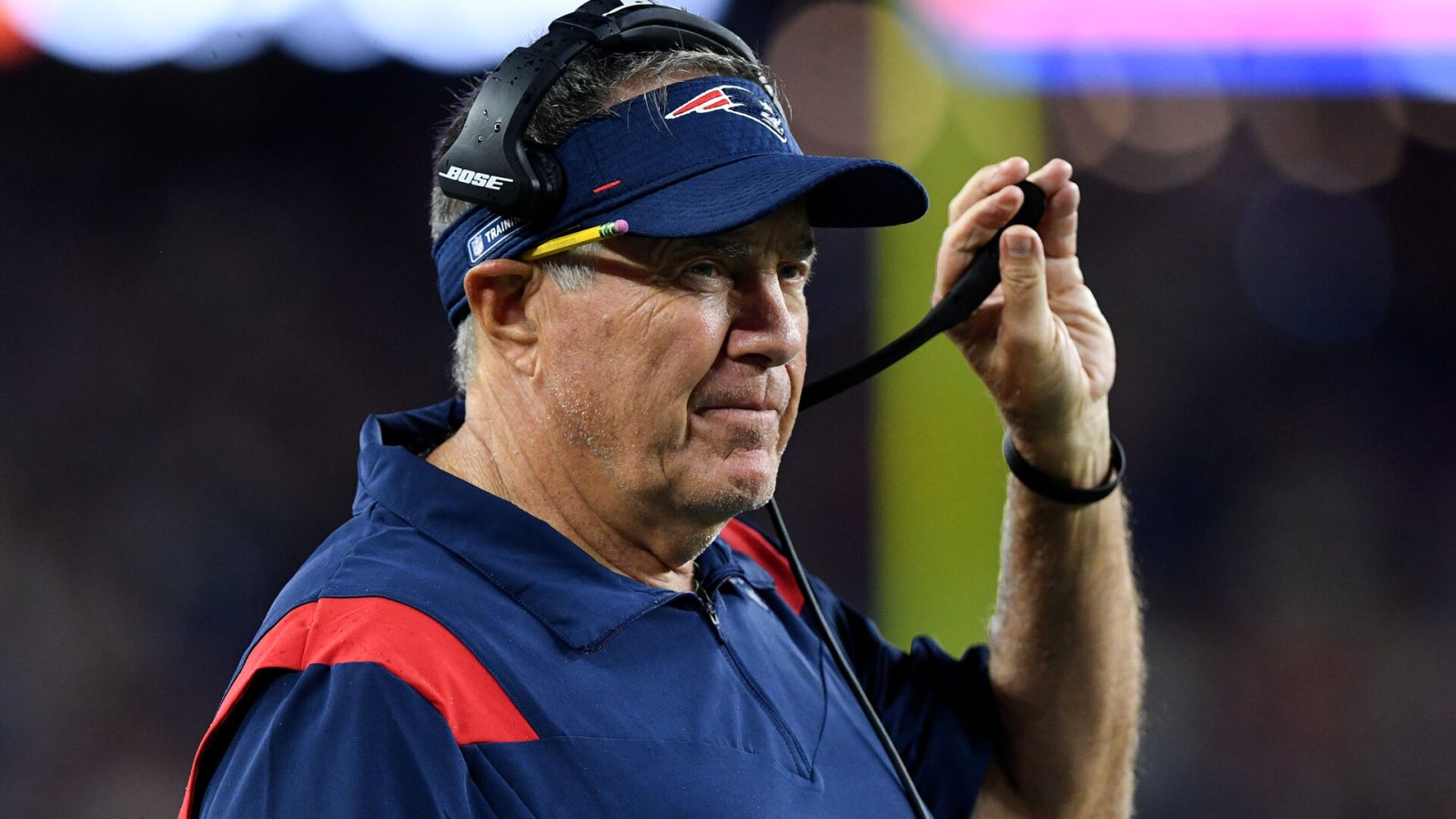New England Patriots head coach Bill Belichick watches a game against the Washington Football Team during the first half at Gillette Stadium.