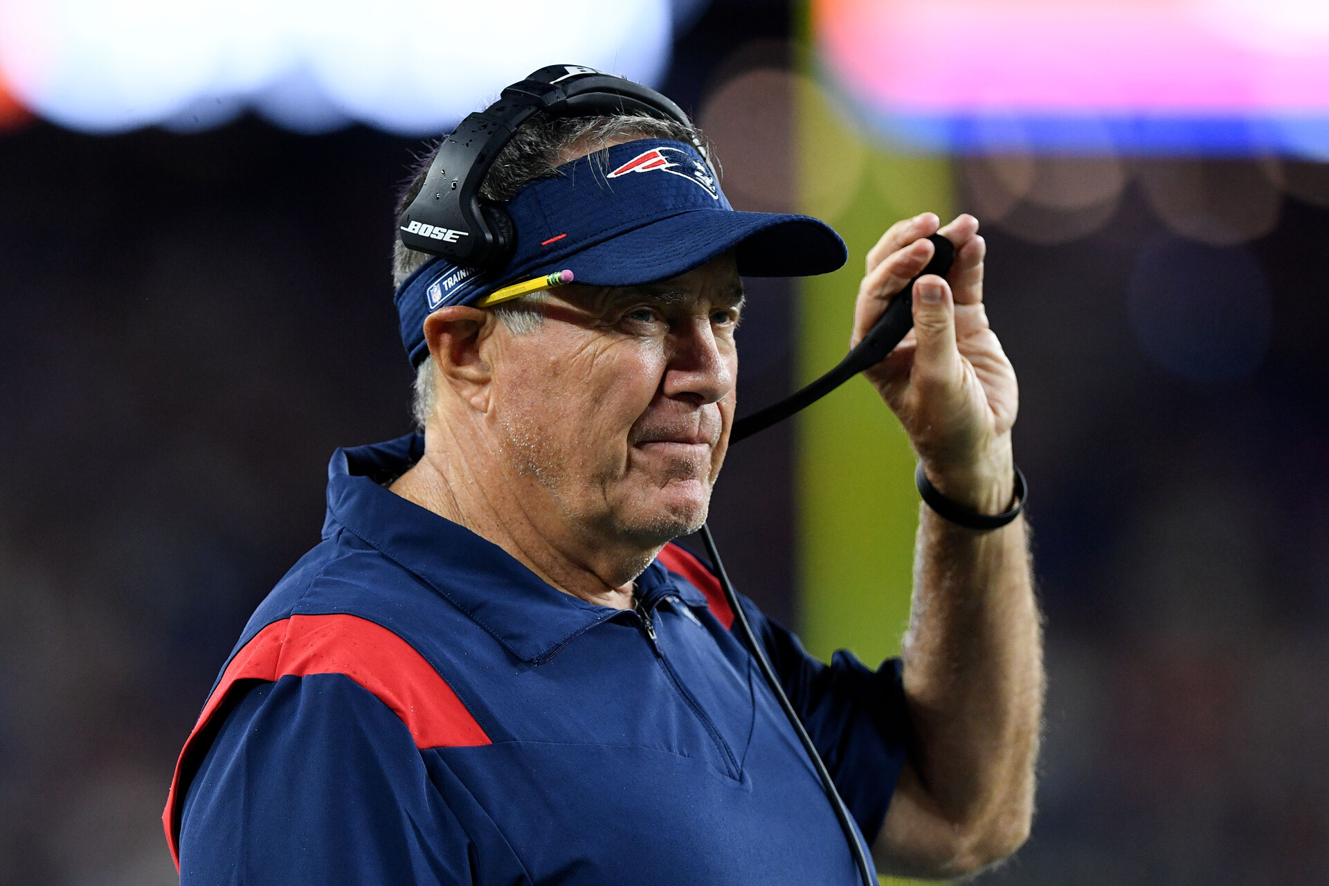 New England Patriots head coach Bill Belichick watches a game against the Washington Football Team during the first half at Gillette Stadium.