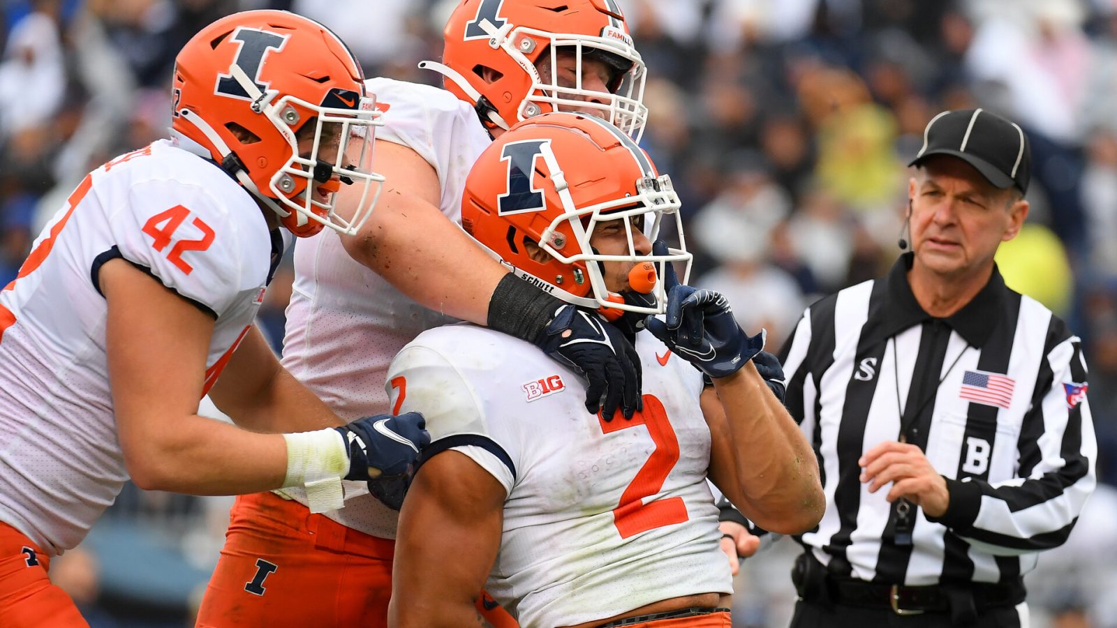 Pennsylvania, USA; Illinois Fighting Illini running back Chase Brown (2) celebrates his touchdown run with teammates against the Penn State Nittany Lions during the first half at Beaver Stadium.