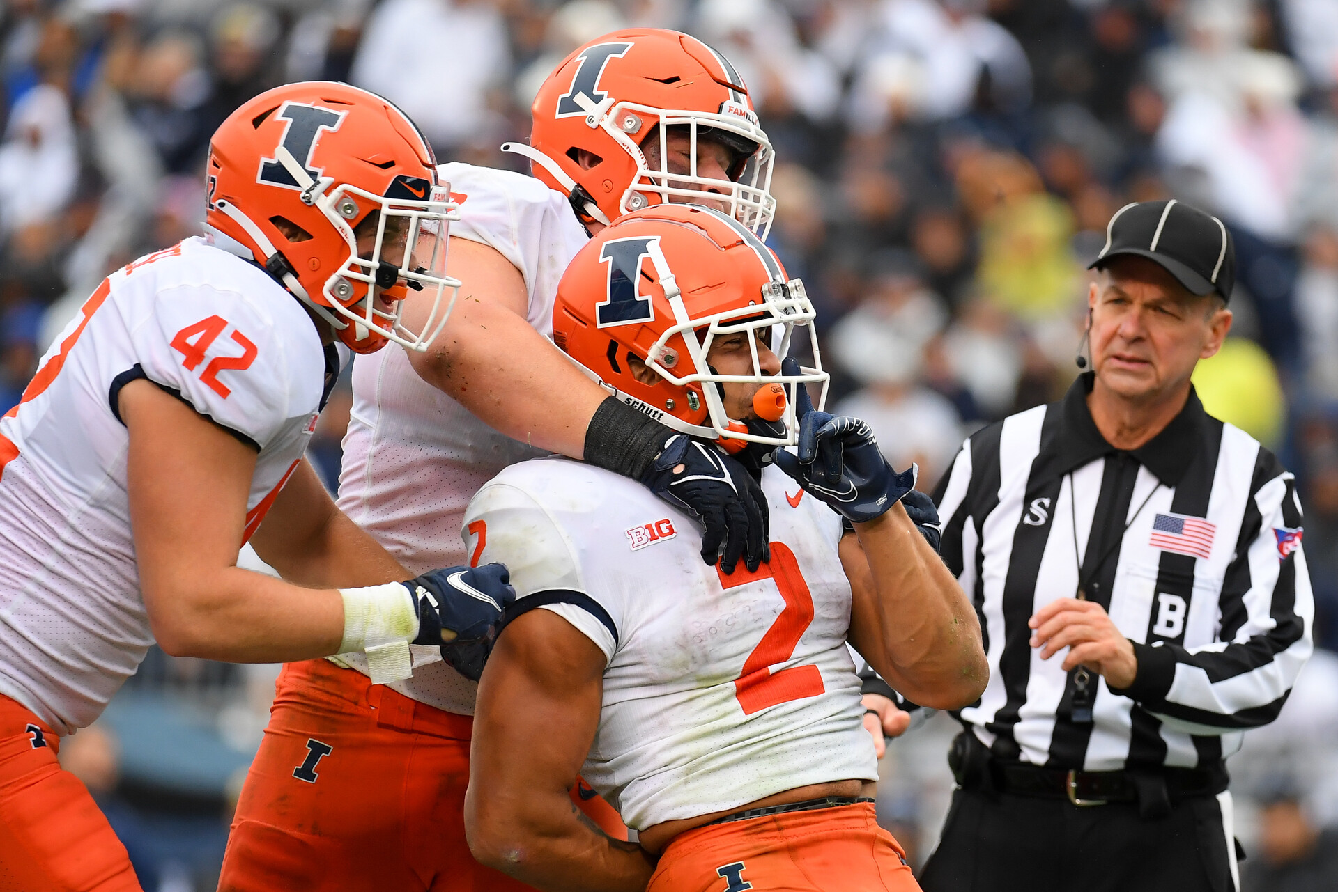 Pennsylvania, USA; Illinois Fighting Illini running back Chase Brown (2) celebrates his touchdown run with teammates against the Penn State Nittany Lions during the first half at Beaver Stadium.