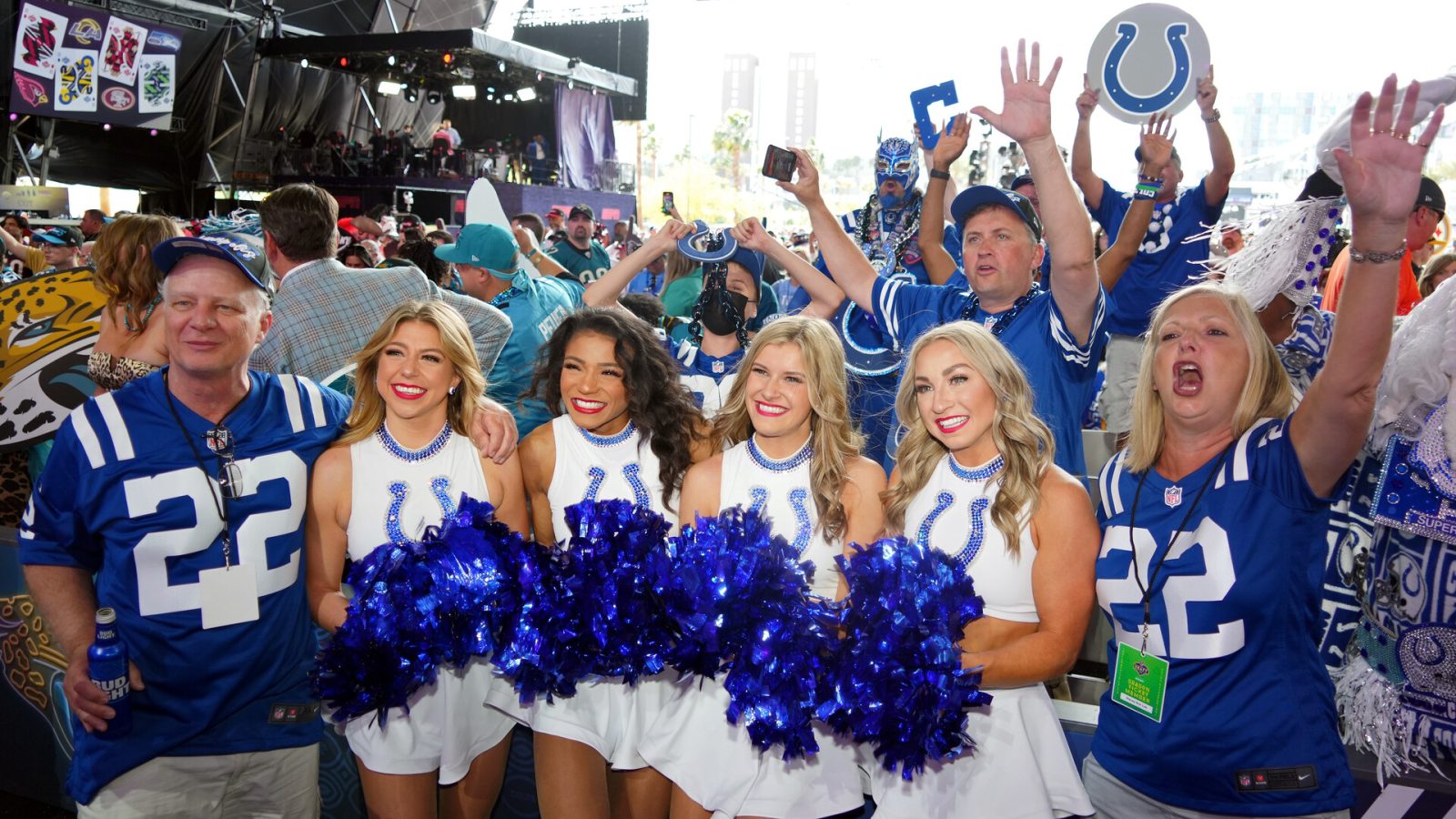 Indianapolis Colts cheerleaders pose for a photo with fans before the first round of the 2022 NFL Draft at the NFL Draft Theater.