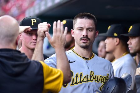 Pittsburgh Pirates center fielder Bryan Reynolds (10) celebrates with teammates after scoring against the St. Louis Cardinals during the first inning at Busch Stadium.
