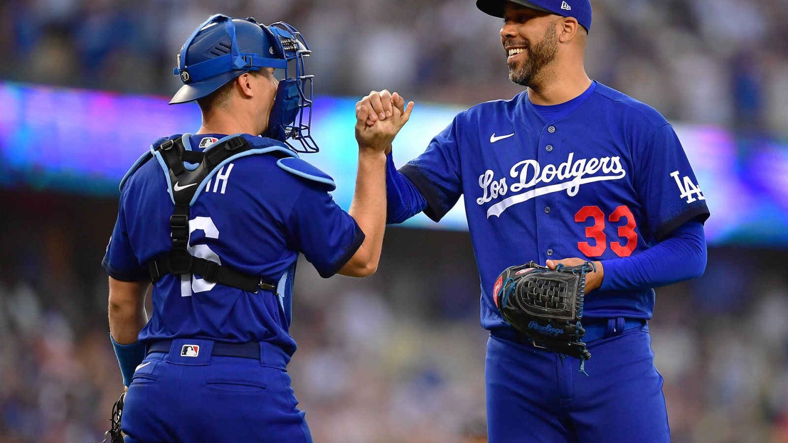 Los Angeles Dodgers catcher Will Smith (16) and relief pitcher David Price (33) celebrate the victory against the San Francisco Giants at Dodger Stadium.
