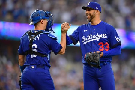 Los Angeles Dodgers catcher Will Smith (16) and relief pitcher David Price (33) celebrate the victory against the San Francisco Giants at Dodger Stadium.