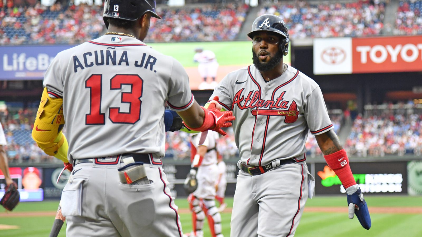 Jul 25, 2022; Philadelphia, Pennsylvania, USA; Atlanta Braves designated hitter Marcell Ozuna (20) celebrates with right fielder Ronald Acuna Jr. (13) after scoring against the Philadelphia Phillies during the second inning at Citizens Bank Park.